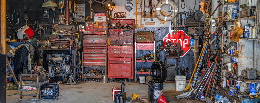 Items in a garage with automotive equipment.
